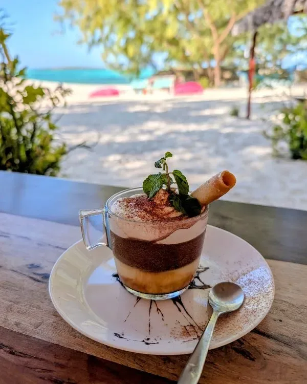 Representative hotel space: A layered dessert topped with mint sits on a plate at an outdoor table.