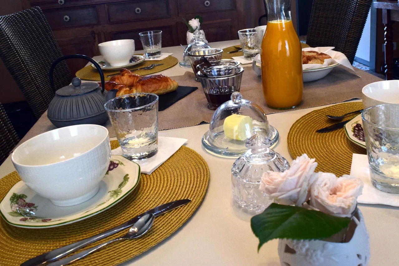 Representative hotel space: A dining table is set with breakfast dishes and orange juice.