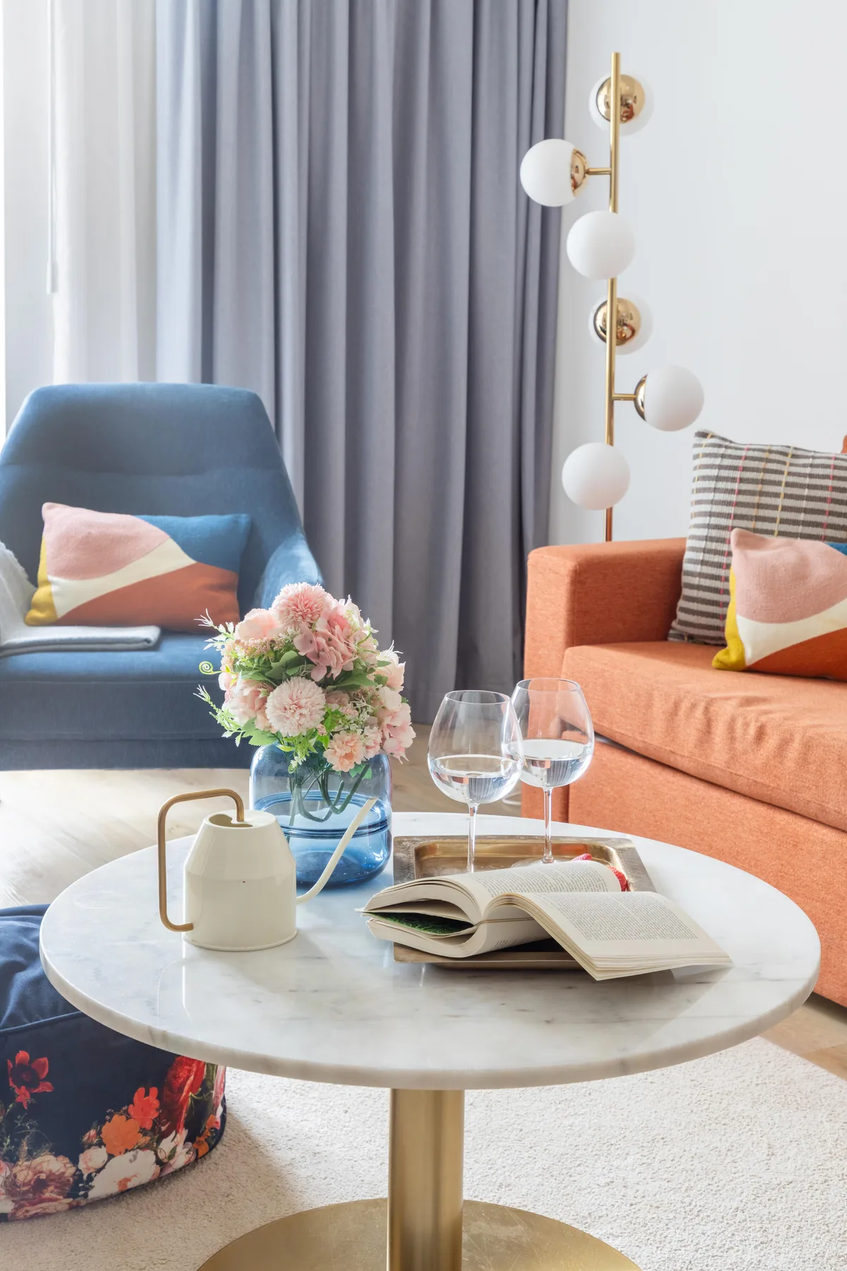 A living room seating area with colorful chairs around a coffee table.