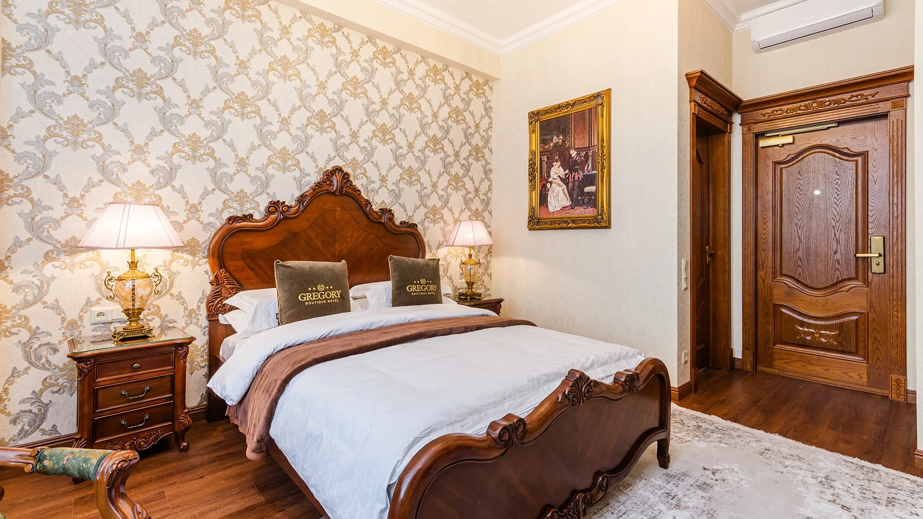Representative hotel space: A bedroom with a wooden bed, bedside tables, and a wooden door.