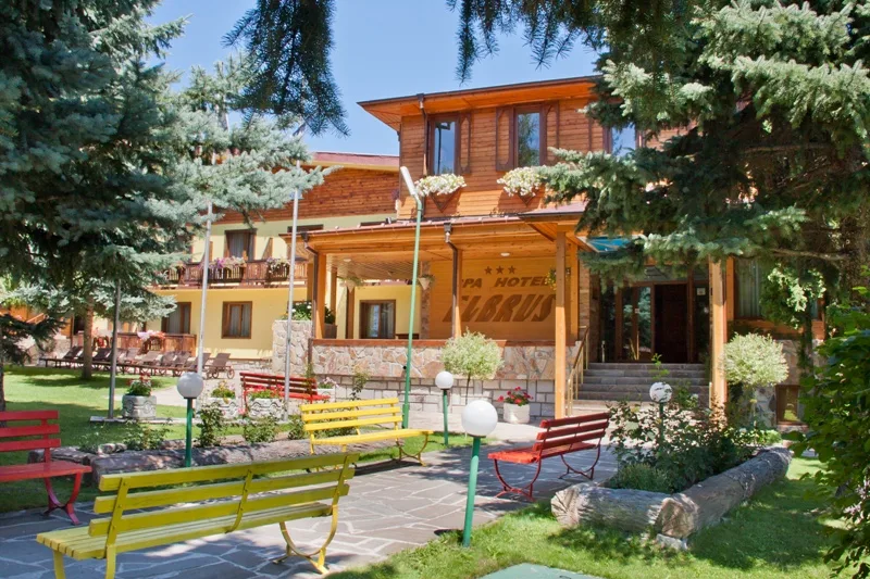 Representative hotel space: A hotel entrance with colorful benches and landscaped grounds.