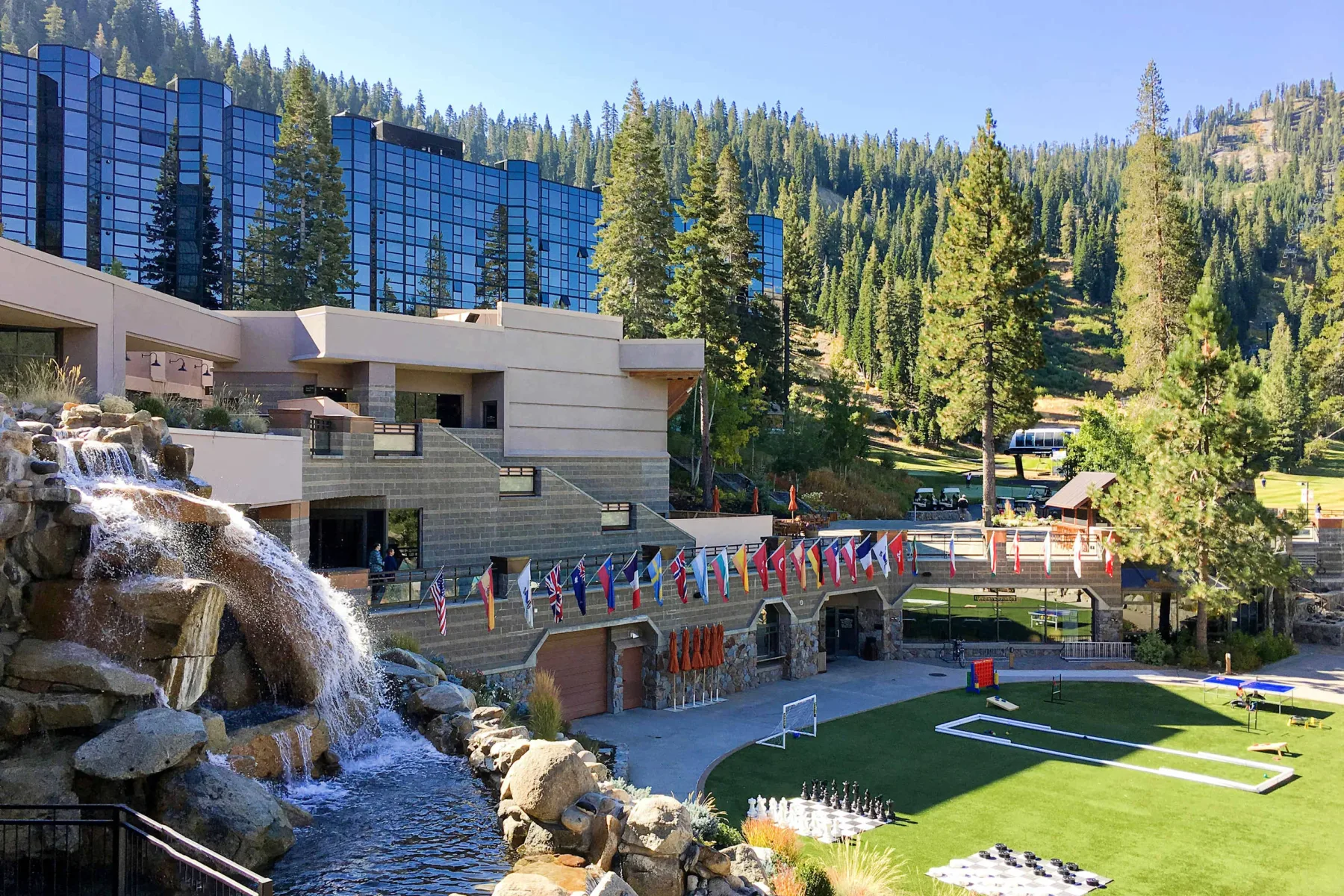 Shared amenity: Outdoor recreation area with a cascading water feature, lawn, and surrounding buildings.