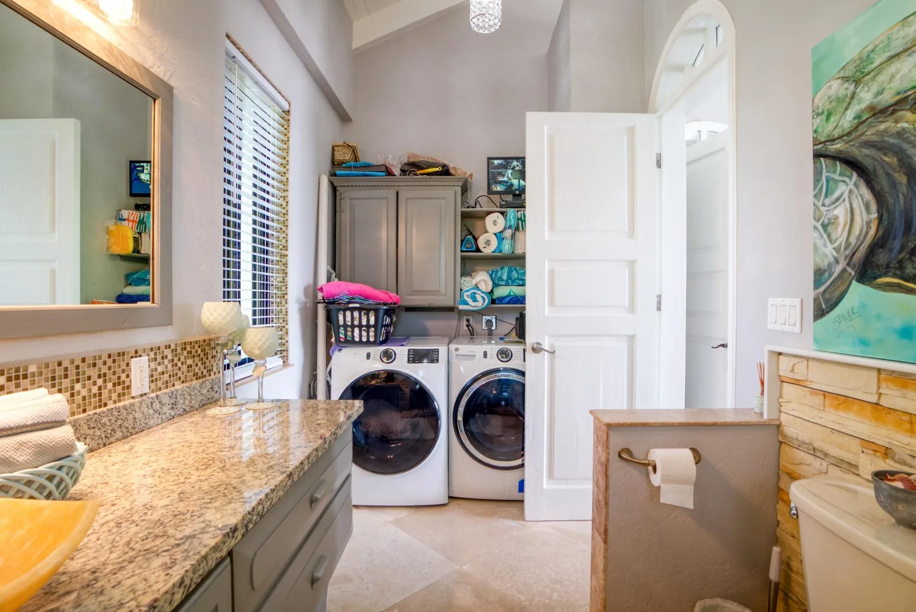 A bathroom vanity and laundry area with a washer and dryer.
