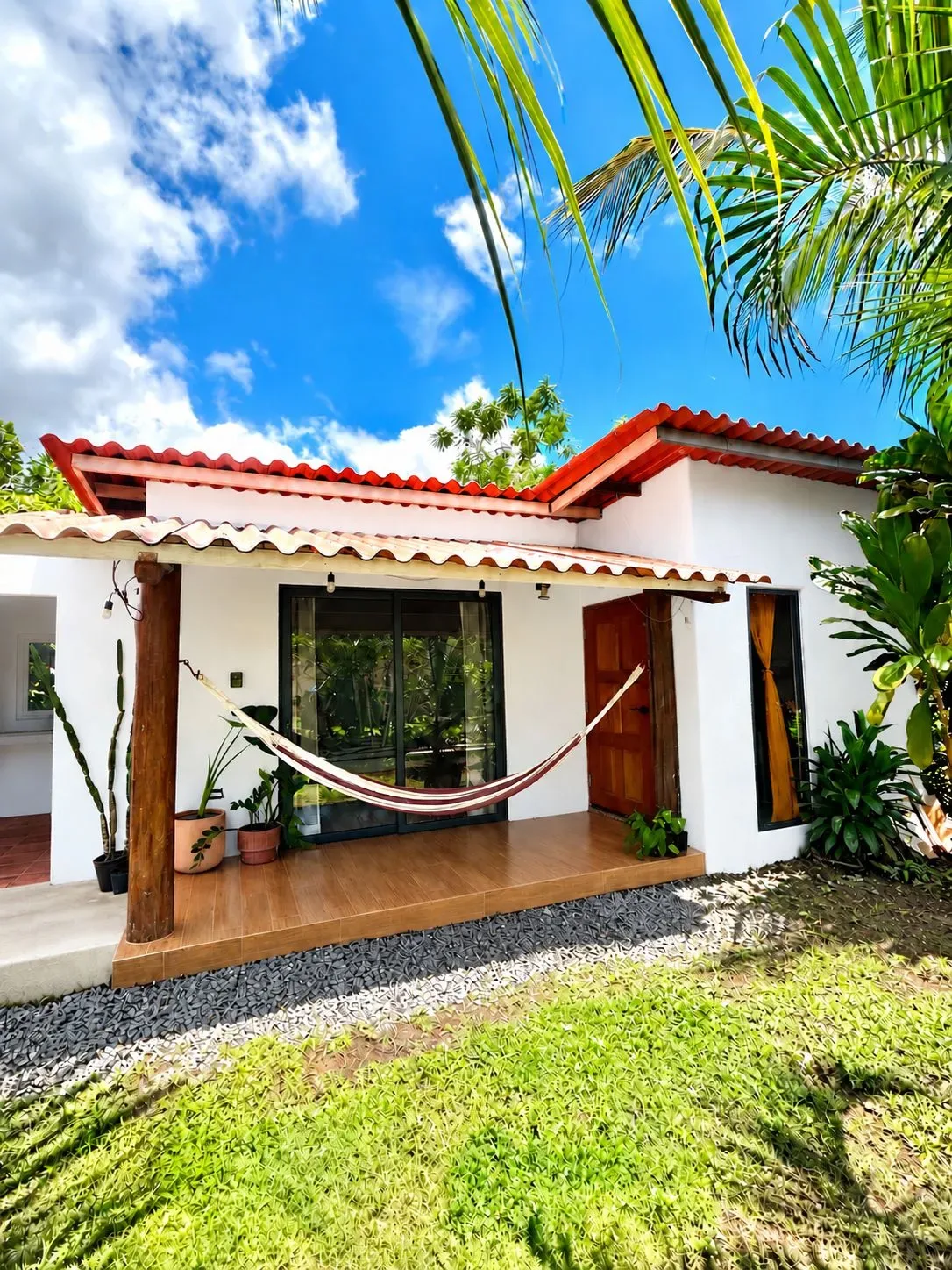 Representative hotel space: A tropical house with a hammock on the covered patio.