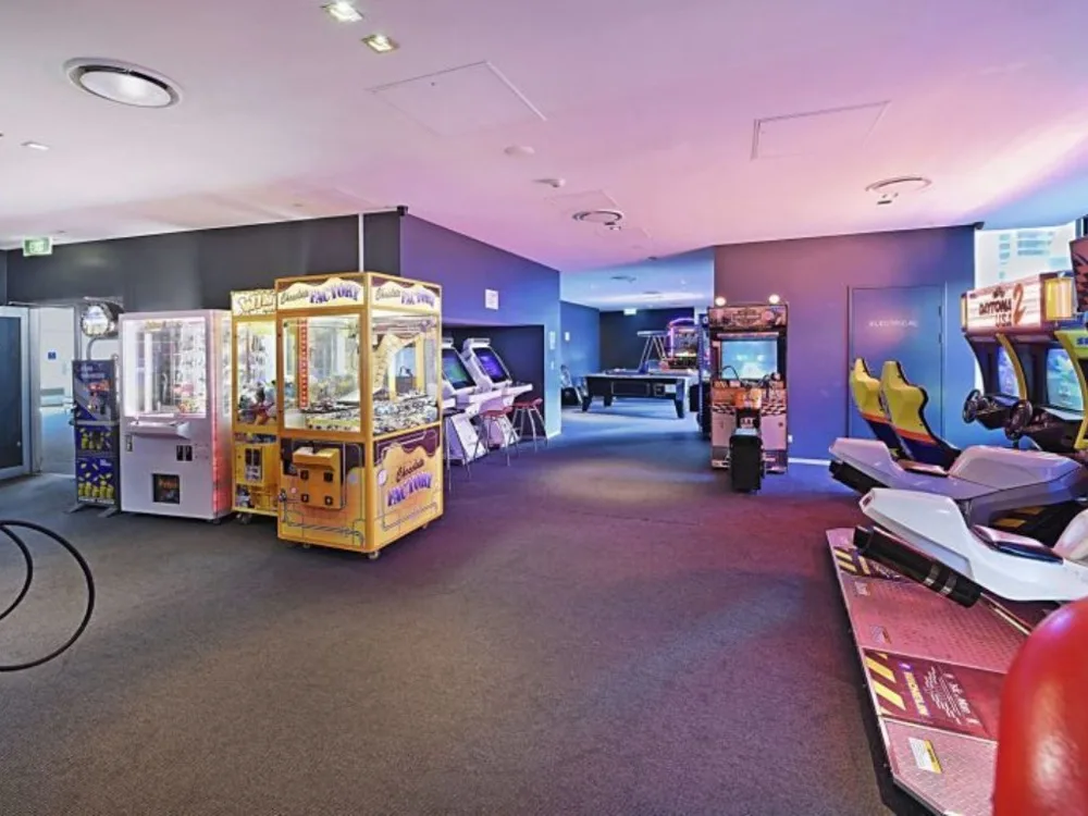Shared amenity: An indoor arcade with colorful game machines and racing games.