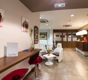 Representative hotel space: A hotel lobby with a reception desk, seating area, and tiled floor.