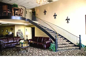 Representative hotel space: A hotel lobby with a staircase and seating area.