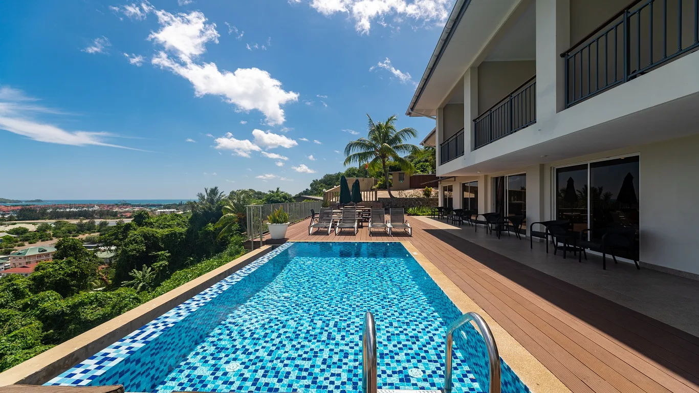 Representative hotel space: An outdoor swimming pool beside a modern multi-story building.