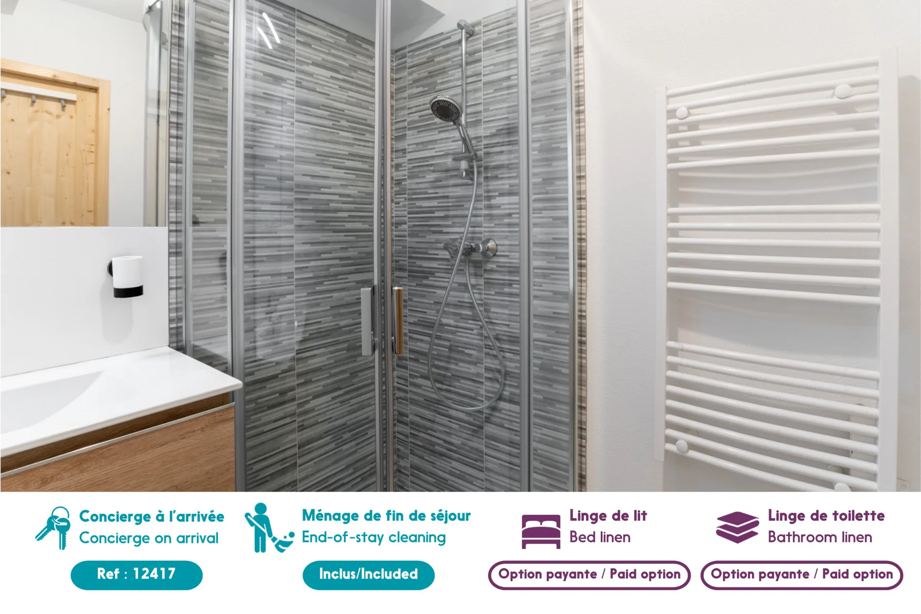 A bathroom with a shower, sink, and wall-mounted towel warmer.