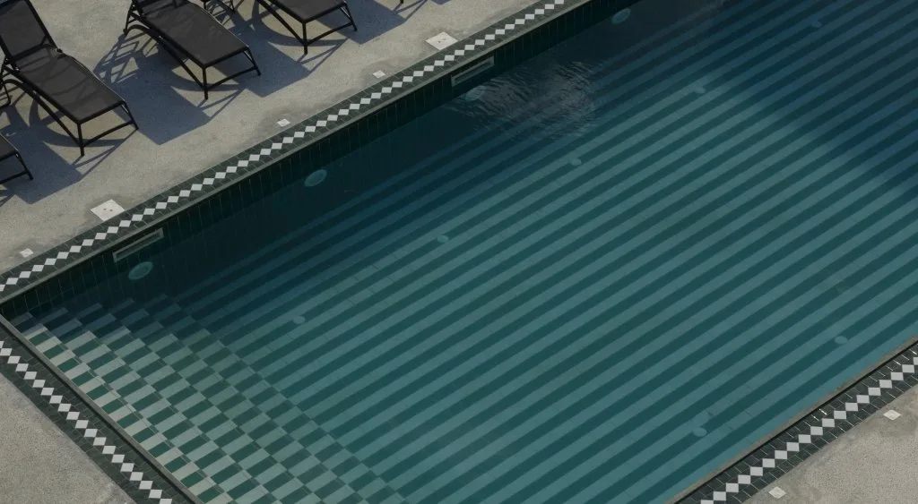 Representative hotel space: An outdoor swimming pool with striped lane markings and deck seating.