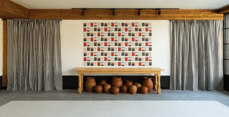 Representative hotel space: A room with a long wooden table beneath a colorful square-patterned wall display.
