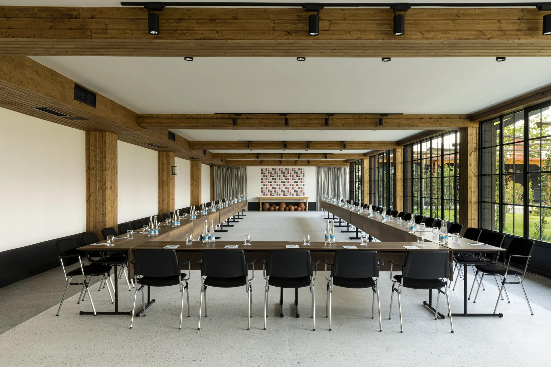 Representative hotel space: A conference room with long tables arranged in a U shape.