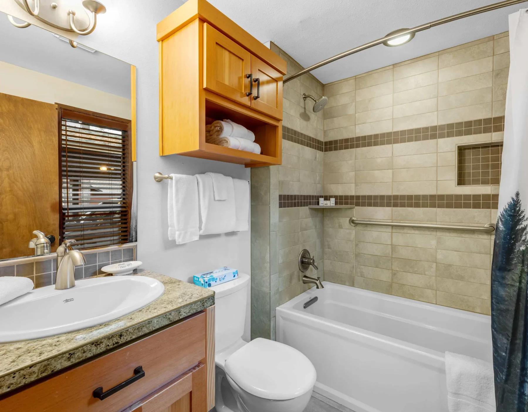 A bathroom with a bathtub, sink, and wall-mounted cabinet.