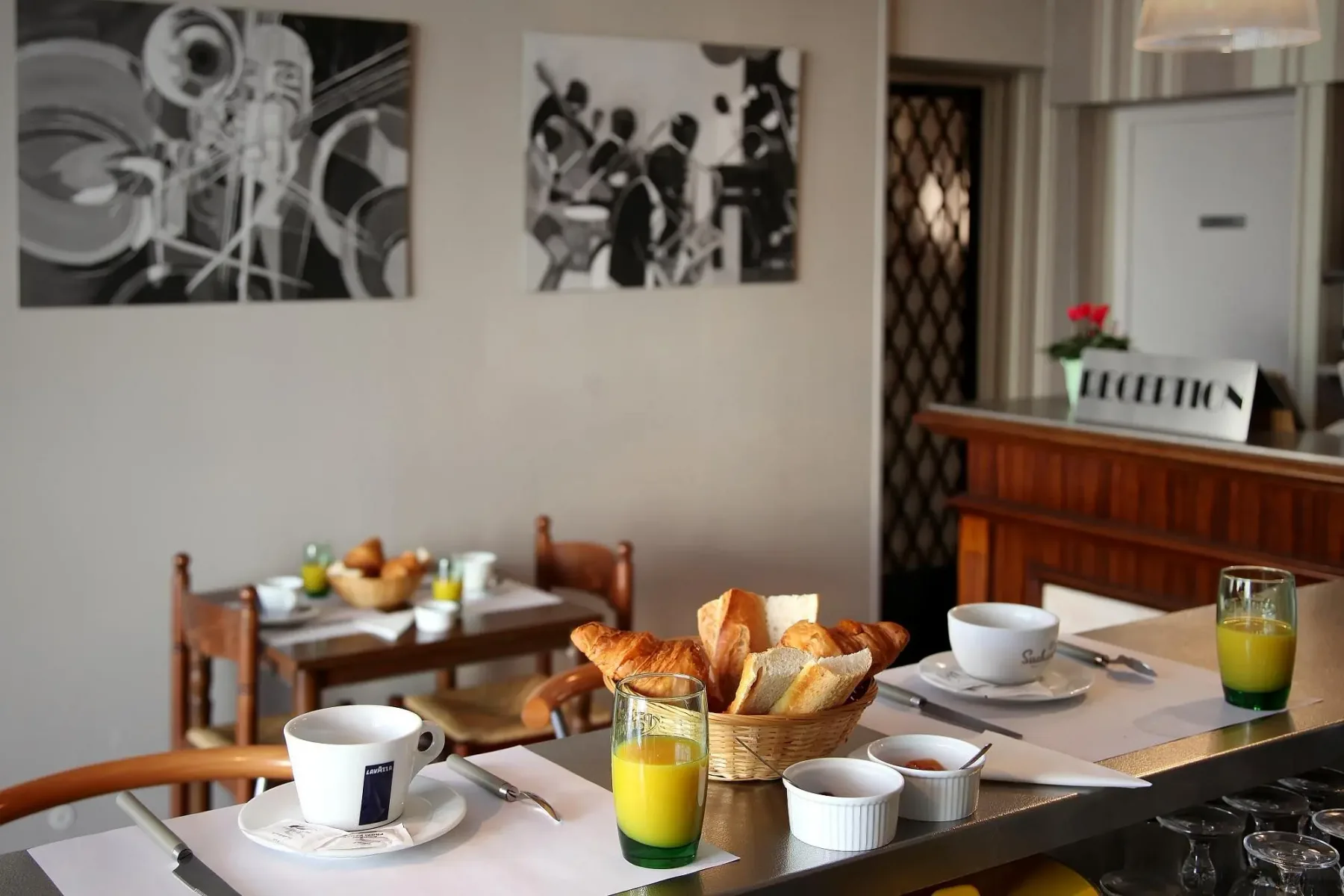 Representative hotel space: A breakfast area with a table set with bread, fruit, and drinks.