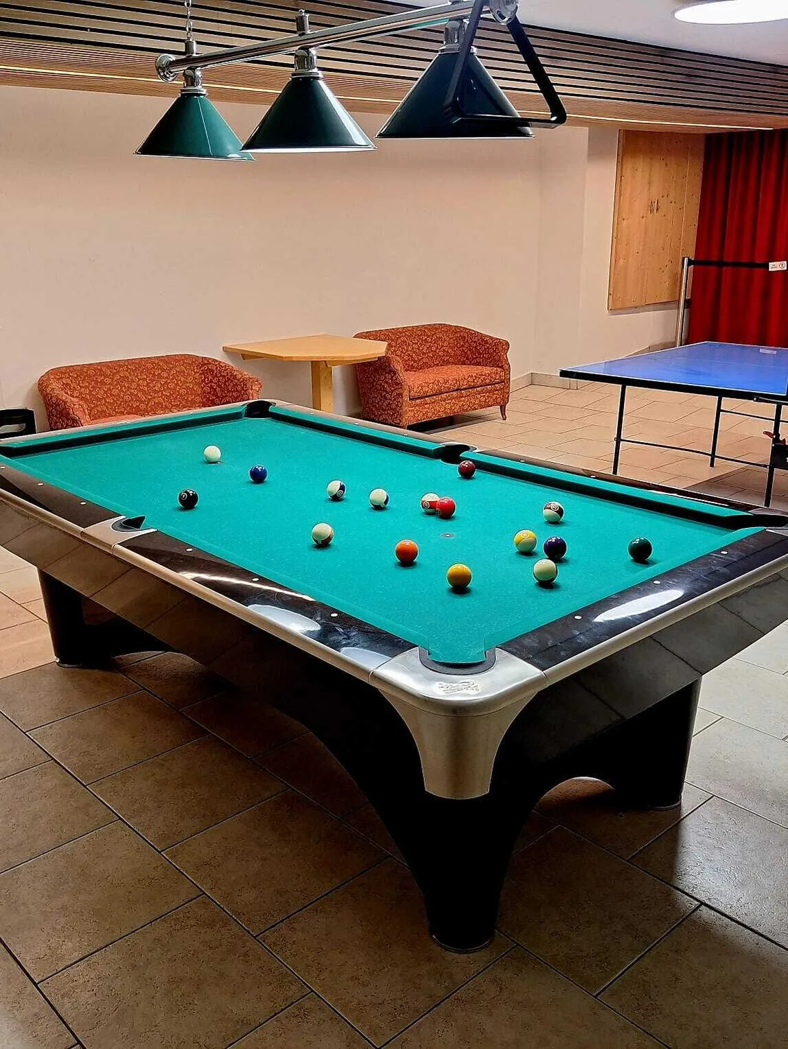 Representative hotel space: A recreation room features a pool table and seating.