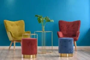 Representative hotel space: A colorful seating area with two chairs and a small table against a blue wall.