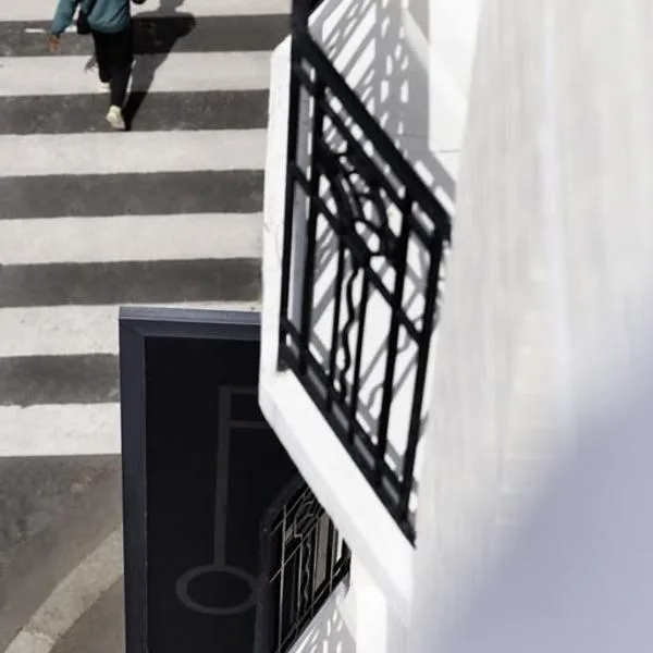 Representative hotel space: Outdoor stairs with alternating light and dark steps beside a black railing.