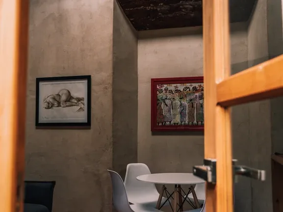 Representative hotel space: A small dining area with a round table and framed artwork on the walls.