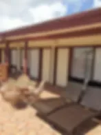 Representative hotel space: A patio dining area with tables and outdoor seating beside the building.