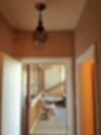 Representative hotel space: A narrow interior hallway opens onto a brighter room.