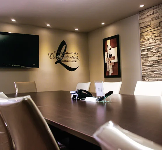 Espacio representativo del hotel: Una sala de reuniones con una mesa grande, sillas y un televisor en la pared.