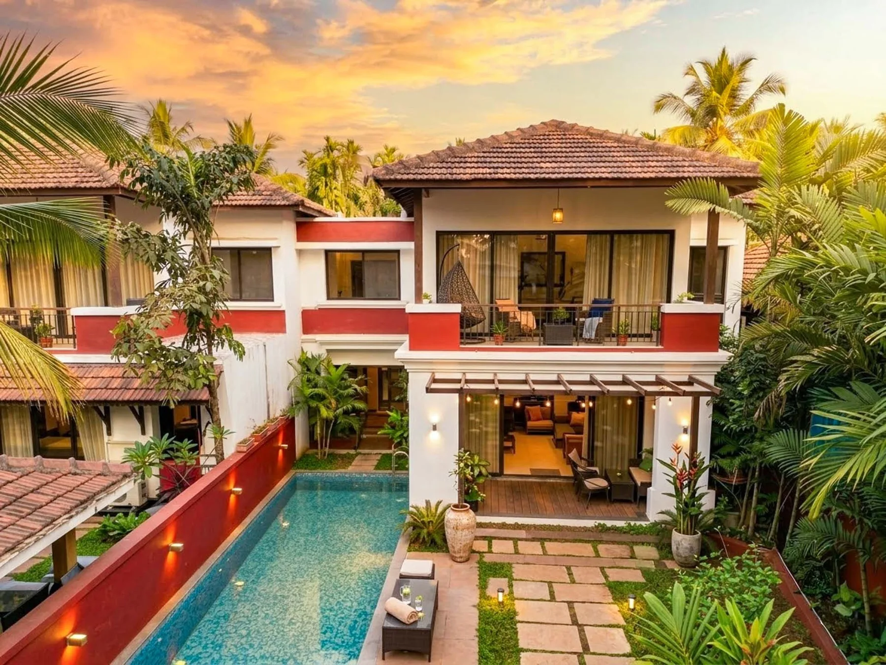 Una villa tropical con piscina y un patio pavimentado.