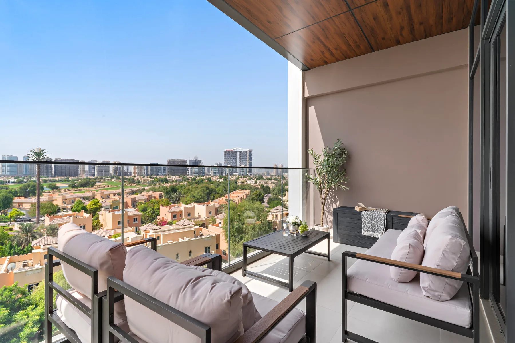 A balcony seating area overlooks a residential neighborhood.