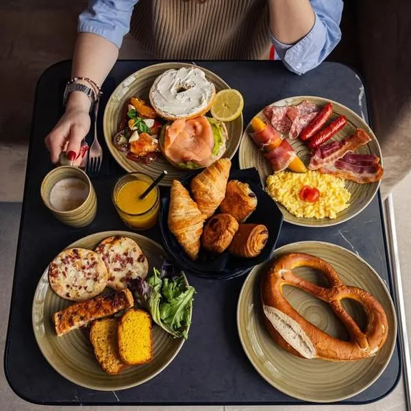 Representative hotel space: A breakfast spread with pastries, eggs, fruit, and assorted savory dishes on a table.