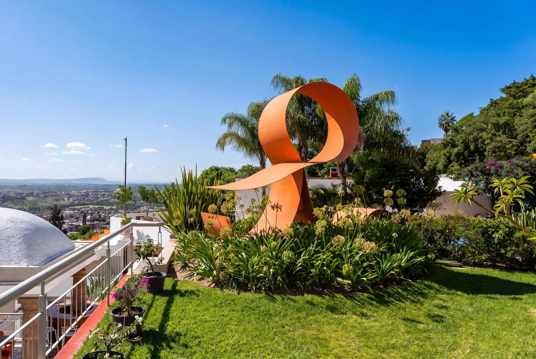Shared amenity: A landscaped garden features a large orange abstract sculpture and city views.