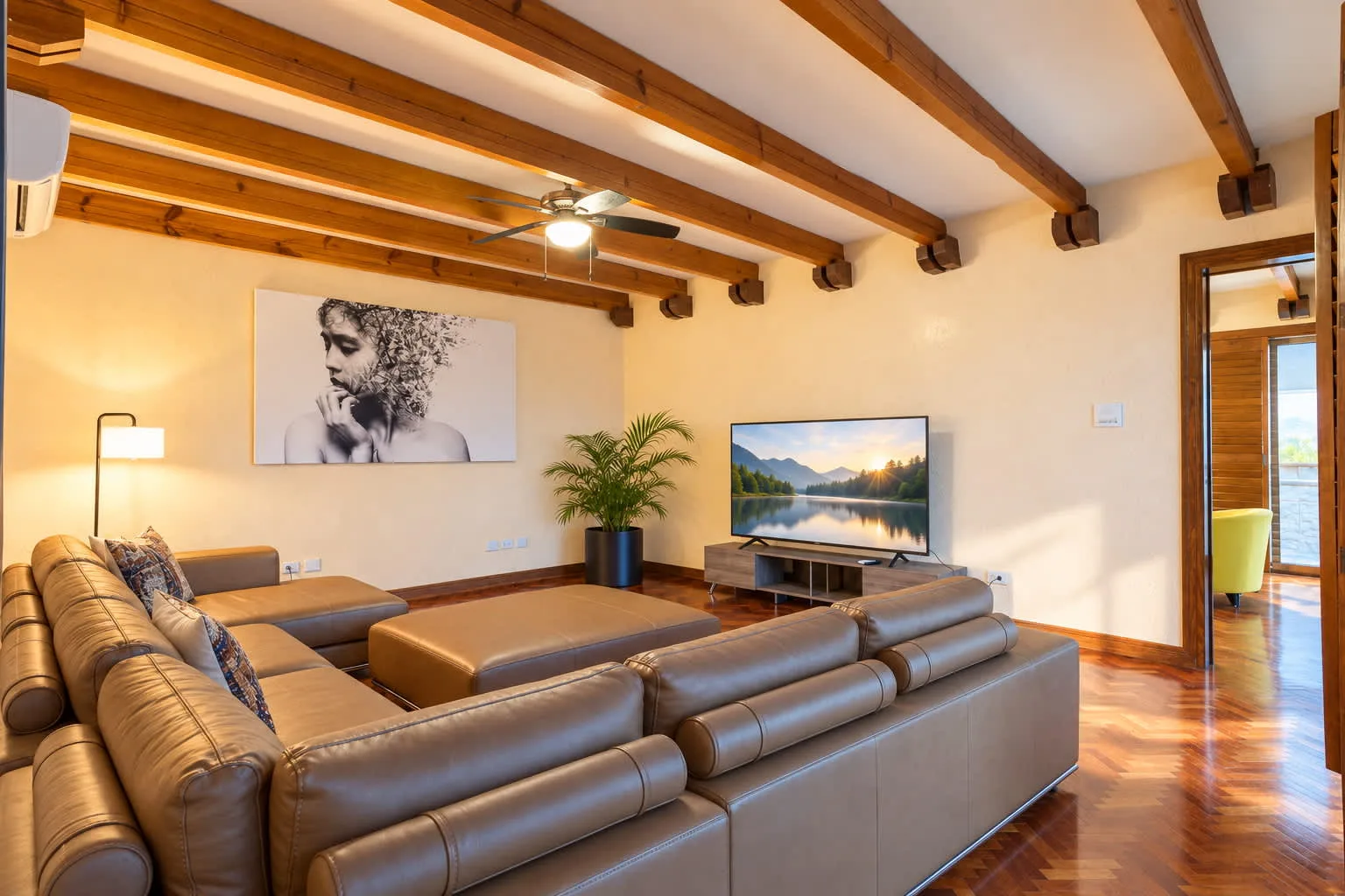 A living room with leather seating, exposed wooden beams, and a television.