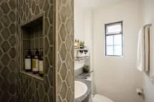 A bathroom with a small window and a shower area.