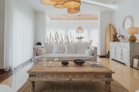 Espacio representativo del hotel: Una sala luminosa con un sofá frente a una mesa de centro de madera.