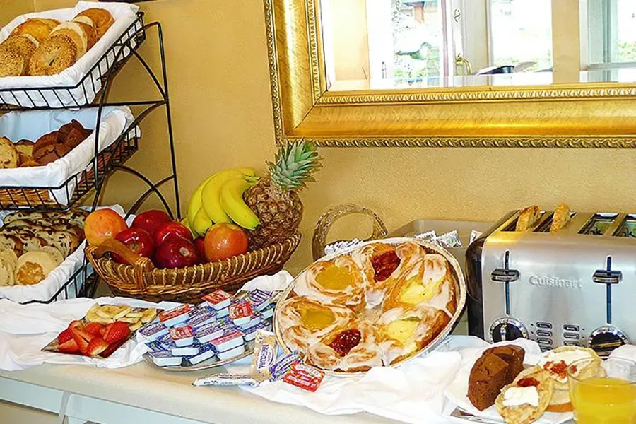 Representative hotel space: A breakfast buffet displays pastries, bread, fruit, and a toaster.