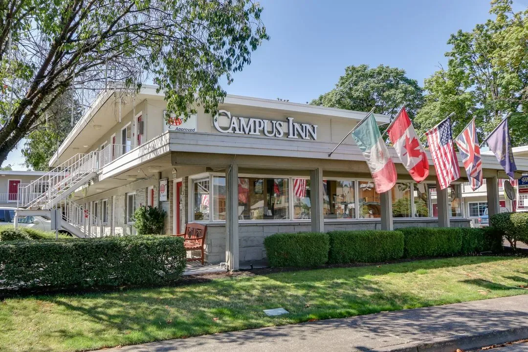 Representative hotel space: A two-story inn building with a row of flags outside.