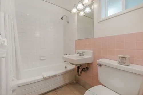 Representative hotel space: A bathroom with a bathtub, sink, and toilet.
