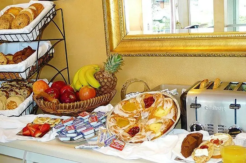 Representative hotel space: A breakfast buffet displays pastries, fruit, and a toaster on a counter.
