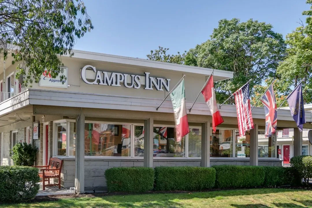 Representative hotel space: Hotel exterior with a prominent sign and several flags outside the entrance.