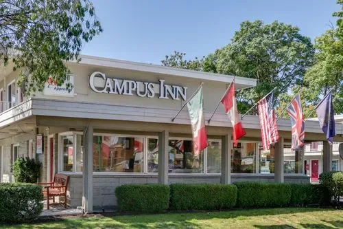 Representative hotel space: Exterior view of the Campus Inn with its sign and flags.