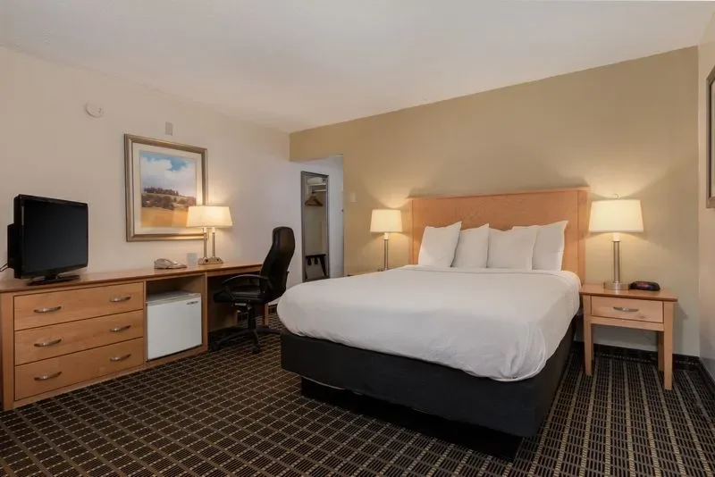Representative hotel space: A hotel bedroom with a bed, desk, and television.