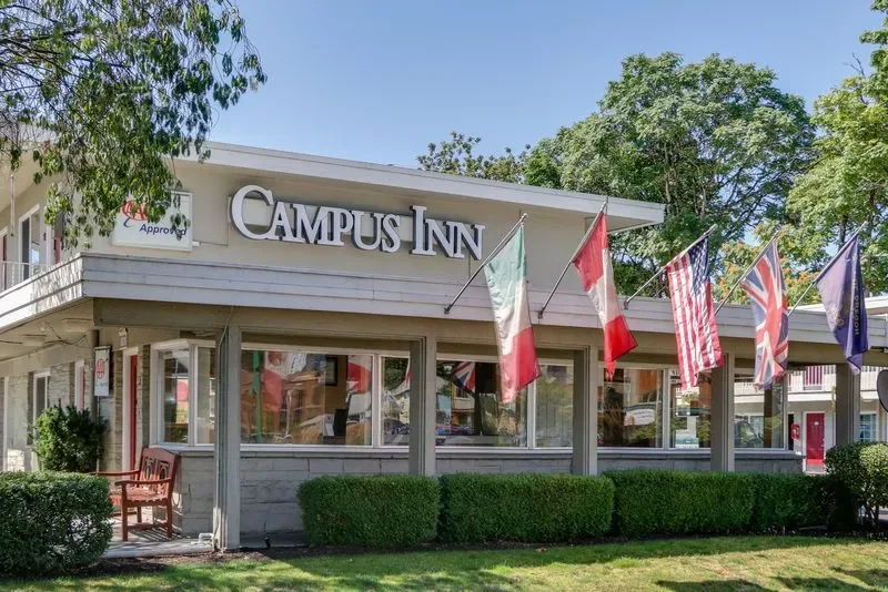 Representative hotel space: Hotel exterior with a prominent Campus Inn sign and flags.