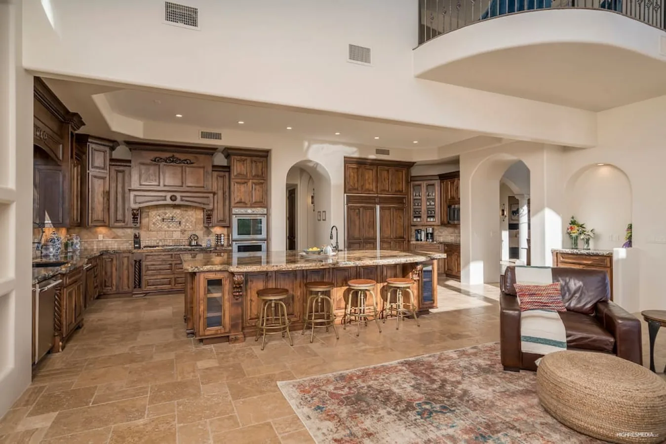 An open kitchen and living area with a large island and seating.