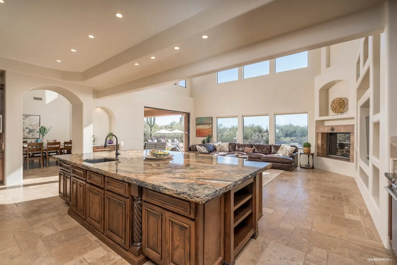 A spacious kitchen with a large island and adjoining living area.