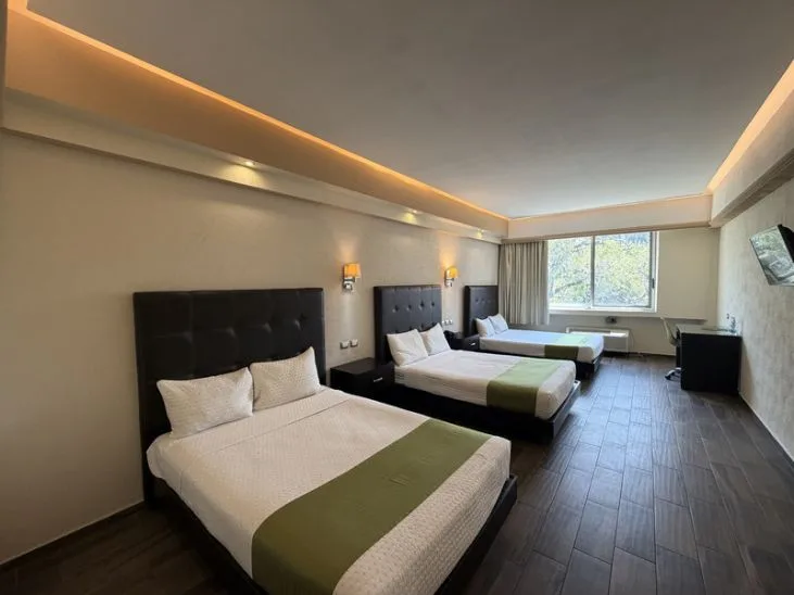 Representative hotel space: A hotel bedroom with two beds and a large window.