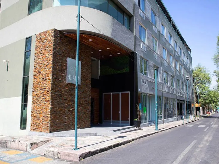 Representative hotel space: A multi-story building with a recessed entrance faces a city street.