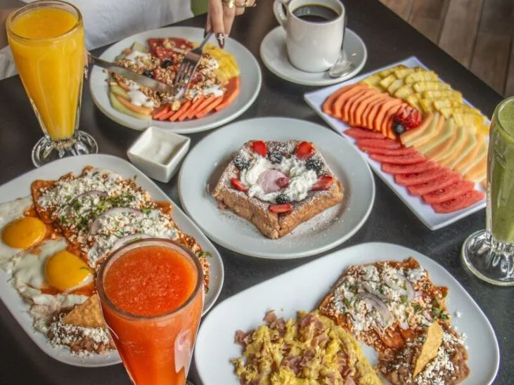 Representative hotel space: Breakfast dishes with fruit, toast, eggs, and juice are arranged on a table.