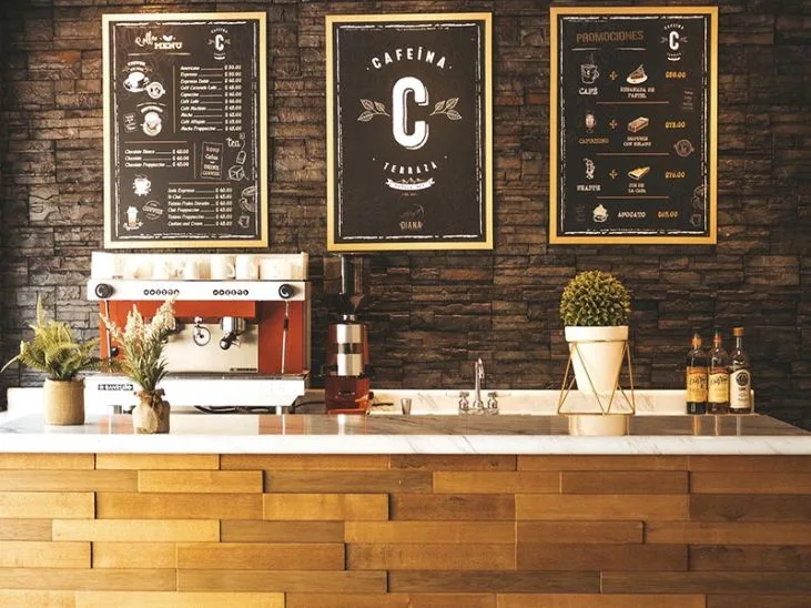 Representative hotel space: A café counter with a coffee machine and menu boards on the wall.