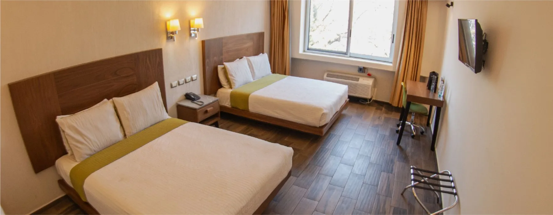 Representative hotel space: A bedroom with two beds and a window.