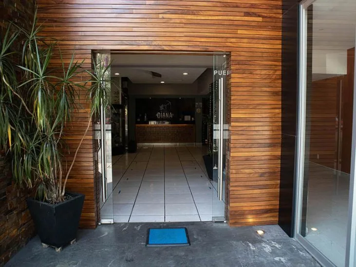 Representative hotel space: A hotel entrance with glass doors and a wood-paneled facade.