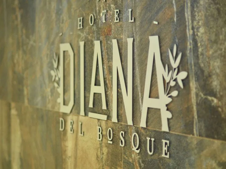 Representative hotel space: A hotel name sign is mounted on a mottled stone wall.