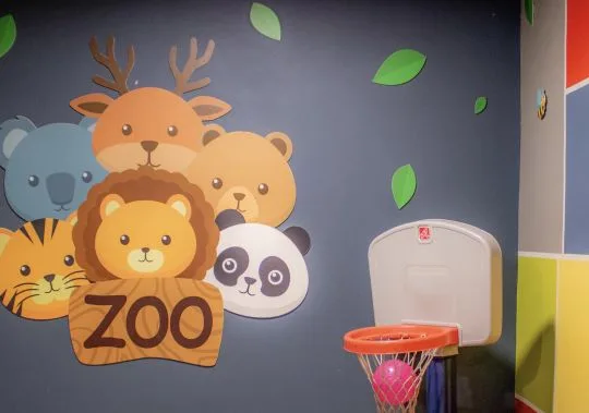 Representative hotel space: A colorful zoo-themed wall mural shows cartoon animals beside a small basketball hoop.